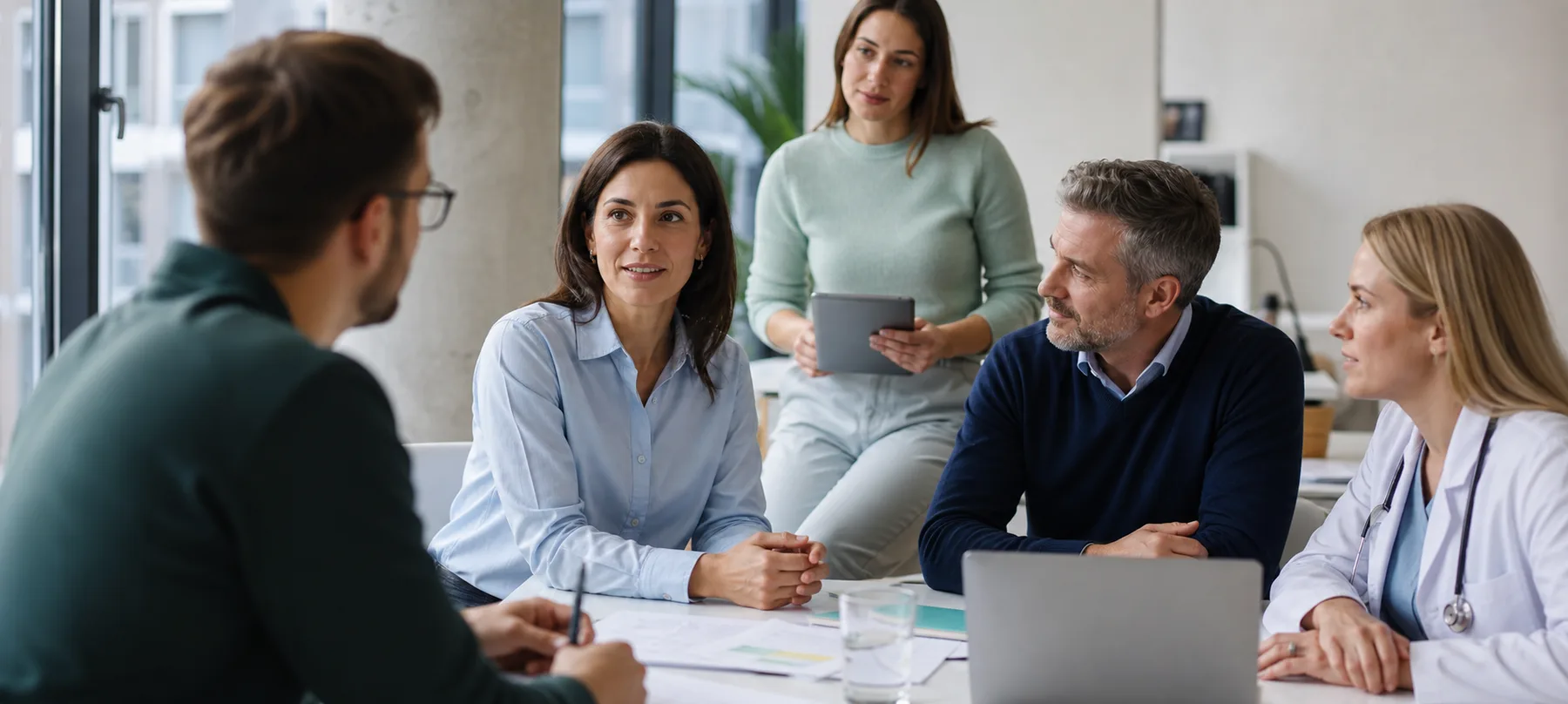 A multidisciplinary Veora Group team collaborating in a bright workplace