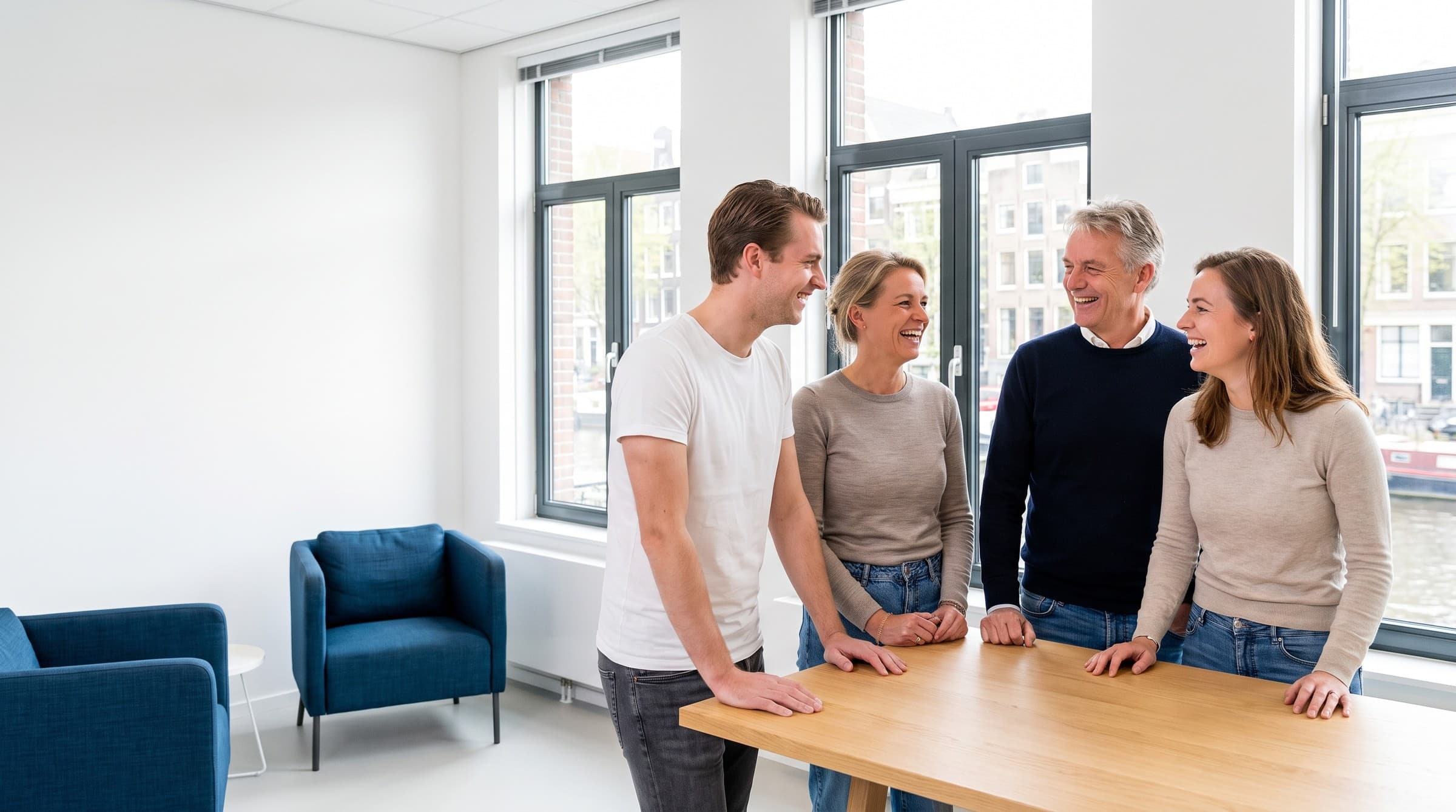 Four colleagues laughing together at the Véora Group office